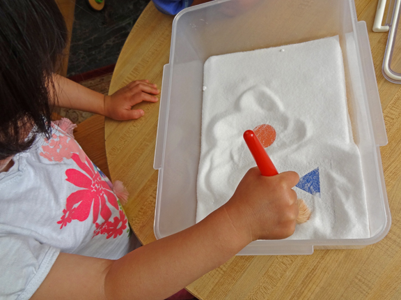 Salt box discoveries: Stimulate early learning by hiding objects (e.g., numbers, letters, colors, shapes) in a salt box for your children to find || Gift of Curiosity