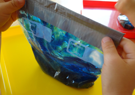 Ocean in a bag - squirt colored hair gel into a plastic bag, then add sand and fish to make an ocean in a bag || Gift of Curiosity