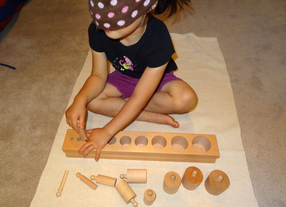 Montessori trays and activities - Sensorial extensions using the knobbed cylinders || Gift of Curiosity