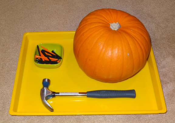 Halloween Montessori activities: Hammering golf tees into a pumpkin || Gift of Curiosity