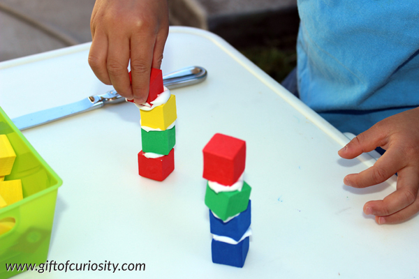 Kids can build structures with foam blocks and shaving cream to practice fine motor skills including spreading and stacking. Plus, the shaving cream adds an additional sensory element to this activity that kids love! #finemotor #sensory #handsonlearning || Gift of Curiosity