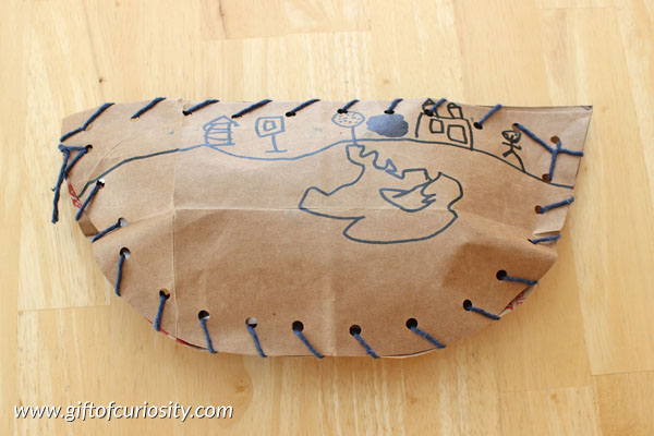 Sew your own pirate ship fine motor craft. Kids can make their own pirate ships by lacing together two sides of a boat cut from grocery store bags. #finemotor || Gift of Curiosity
