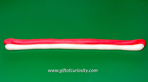 Candy cane play dough: Do you know the secret ingredient that turns regular play dough into candy cane play dough? This would make a great Christmas sensory play activity! || Gift of Curiosity