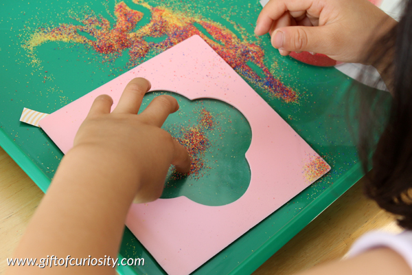 Sand shapes: a shapes, art, and fine motor activity kids love! My daughter loved this activity and went crazy creating all sorts of sand shapes she could then put on her wall! || Gift of Curiosity