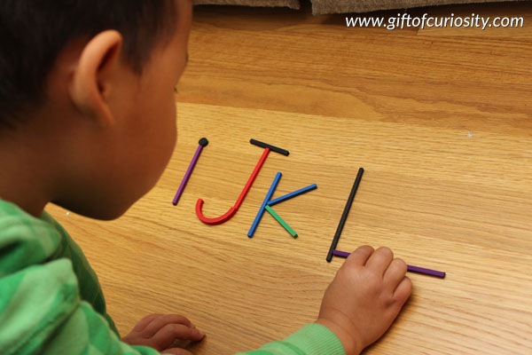 Building letters with sticks: One of many hands-on ideas for building alphabet knowledge that go beyond simple letter recognition to help your child get ready for reading || Gift of Curiosity