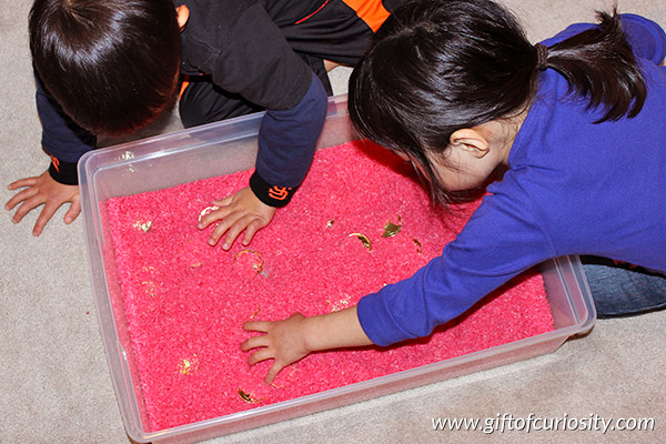 Chinese New Year sensory bin using dyed rice and Chinese-themed objects. What a fun idea for a Chinese New Year party for kids! || Gift of Curiosity