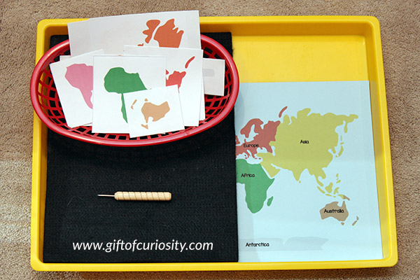 Pin punching the continents, one of four simple Montessori activities for teaching the continents to young kids. || Gift of Curiosity