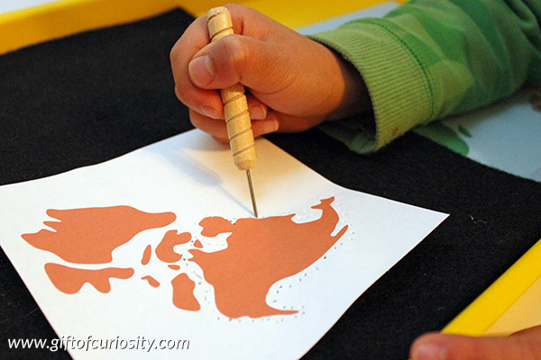 Pin punching the continents, one of four simple Montessori activities for teaching the continents to young kids. || Gift of Curiosity