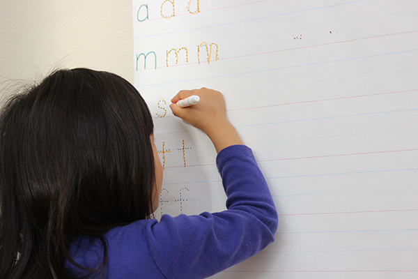 Wall writing: A great way for children to practice writing letters while also strengthening muscles in the shoulders, arms, and hands || Gift of Curiosity