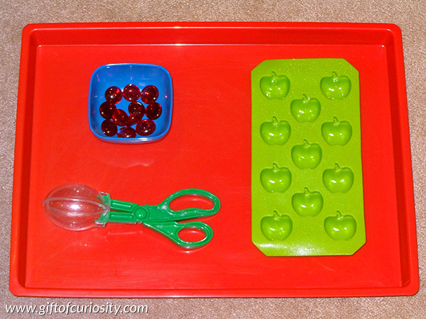 Apple fine motor Montessori activity: Part of a collection of apple-themed Montessori activity ideas for kids ages 2-5. || Gift of Curiosity
