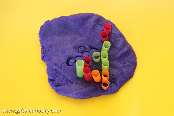 Making letters with straws and play dough is a great way to teach the alphabet. Kids will love learning letters with this tactile sensory and fine motor experience. Part of the 101 Ways to Teach the Alphabet Series from Gift of Curiosity