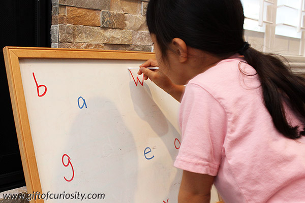 Erasing letters with a Q-tip is a simple-to-set-up activity that works on letter recognition, the proper strokes for writing letters, and fine motor skills needed for writing. I love how this activity can be adapted to help kids with any letters of the alphabet they need assistance with. || Gift of Curiosity