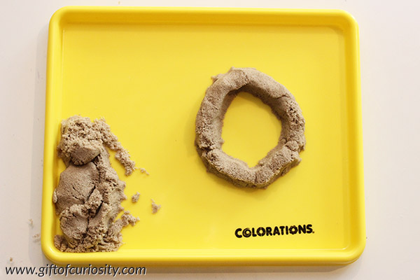 Making letters with kinetic sand is a great way to make learning letters into a fun sensory activity. Part of the 101 Ways to Teach the Alphabet series from Gift of Curiosity