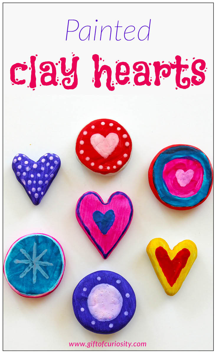 Painted clay hearts make a wonderful Valentine's Day craft. These would be perfect for kids to give away at a Valentines party! || Gift of Curiosity