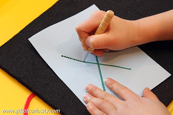 Poking and sewing letters develops fine motor skills and letter knowledge at the same time. What a fun activity for teaching the alphabet and helping kids to learn their letters! || Gift of Curiosity