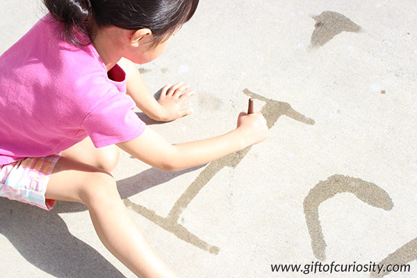 Teach kids to write their letters using "magic paint," a one-ingredient "paint" that makes a mark and then quickly disappears. This is a fun, outdoor activity for teaching the alphabet. My kids would LOVE this idea! || Gift of Curiosity