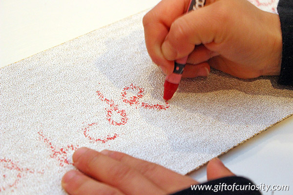 Writing letters on sandpaper combines letter learning with a fun and engaging sensory experience. What a fun way to teach the alphabet! || Gift of Curiosity