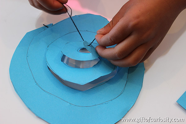 How do hurricanes form? With a spiral cut piece of paper and a lamp, you can model how hot air rises off the ocean to create a hurricane over warm water. This is a great way for kids to learn about extreme weather. || Gift of Curiosity