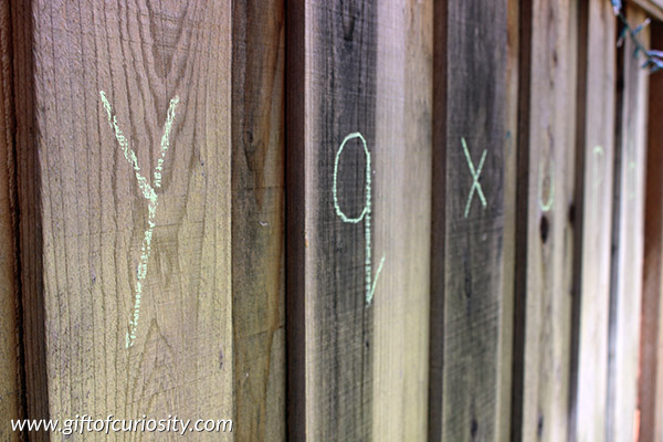 Grab a water gun and some sidewalk chalk, then head outside to enjoy some letter learning fun. What a fun alphabet activity for summer! || Gift of Curiosity