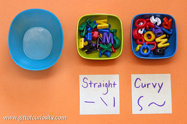 Sorting letters by their physical characteristics (e.g., straight and curvy lines) is a great way for young learners to attend to the shapes of letters {101 Ways to Teach the Alphabet} || Gift of Curiosity