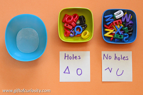Sorting letters by their physical characteristics (e.g., holes vs no holes) is a great way for young learners to attend to the shapes of letters {101 Ways to Teach the Alphabet} || Gift of Curiosity