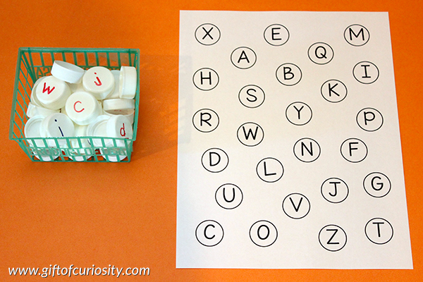 Free printable Milk Cap Letter Matching activity to work on matching uppercase and lowercase letters of the alphabet. When a fun way to teach the alphabet! || Gift of Curiosity