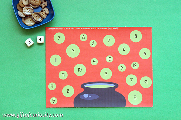 FREE printable Halloween Roll & Cover Math Games. This download includes 3 different games: a number recognition game, a basic addition game, and a basic subtraction game. || Gift of Curiosity