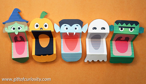 Witch, pumpkin, vampire, ghost, and Frankenstein puppets with mouths open